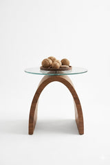 Contemporary glass top accent table with wooden arch base